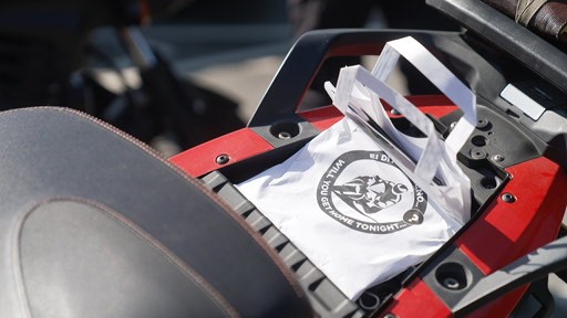 Photograph of a campaign goodie bag on the back of a motorcycle