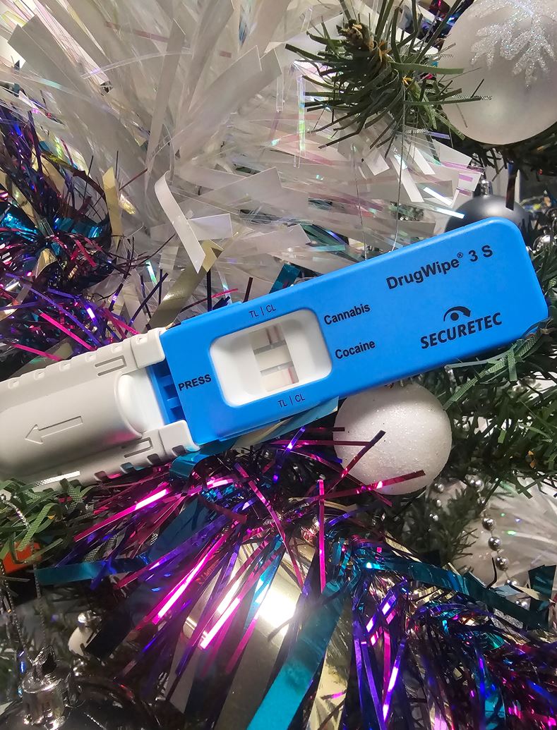 Photograph of a drug wipe surrounded by tinsel